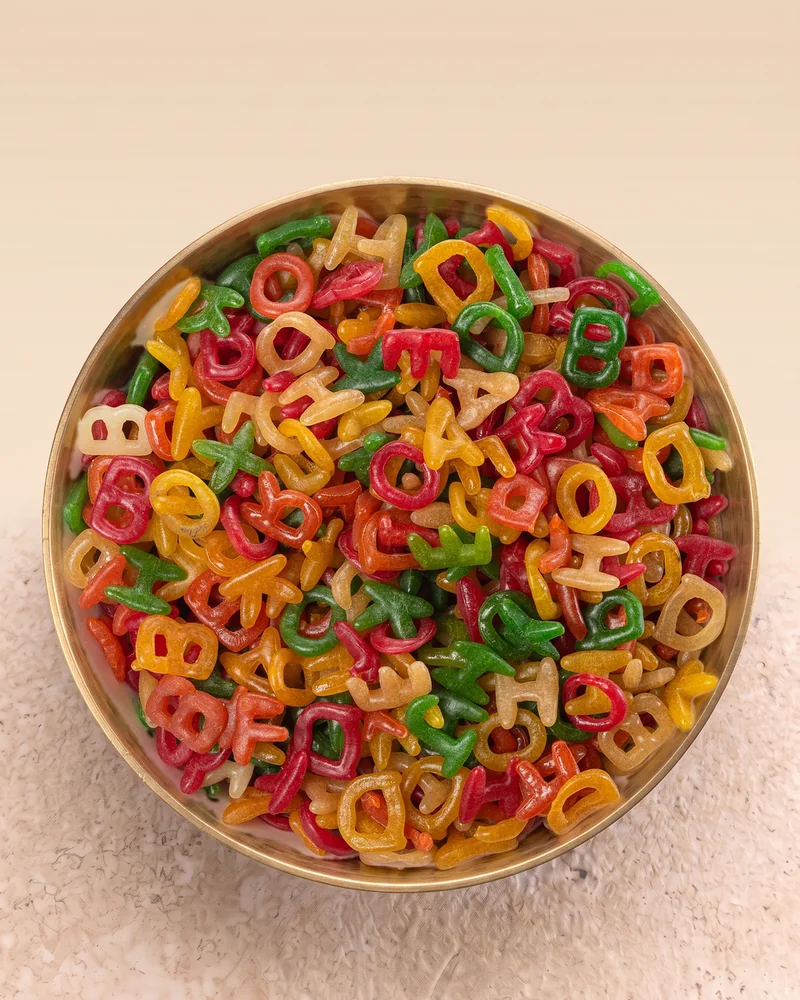 A bowl of Suvidha Papad ABCD alphabet fryums, seen from above